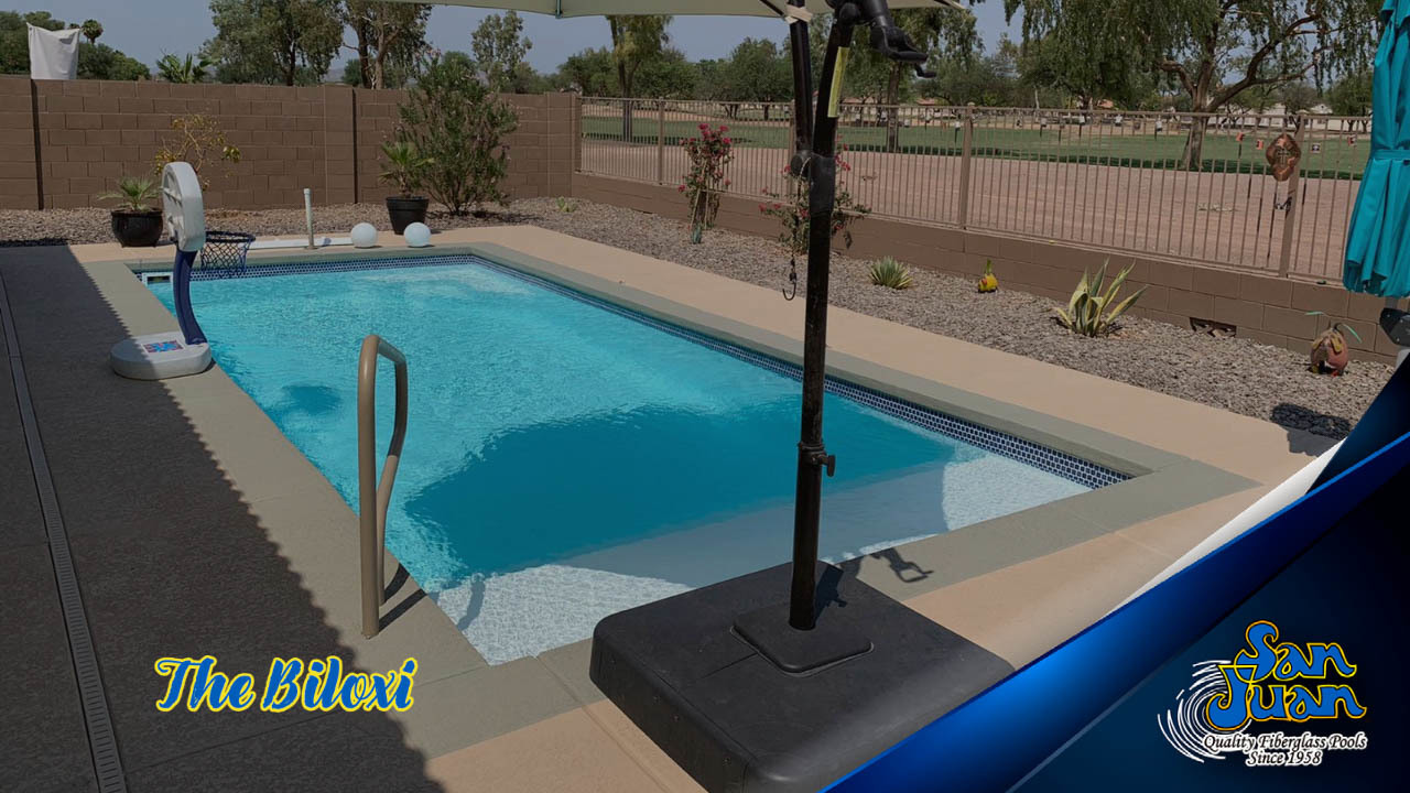 A serene fiberglass pool in a tranquil backyard setting, perfect for relaxation and resort-style living. The warm, natural tones and medium contrast create a soothing atmosphere, ideal for any season.
