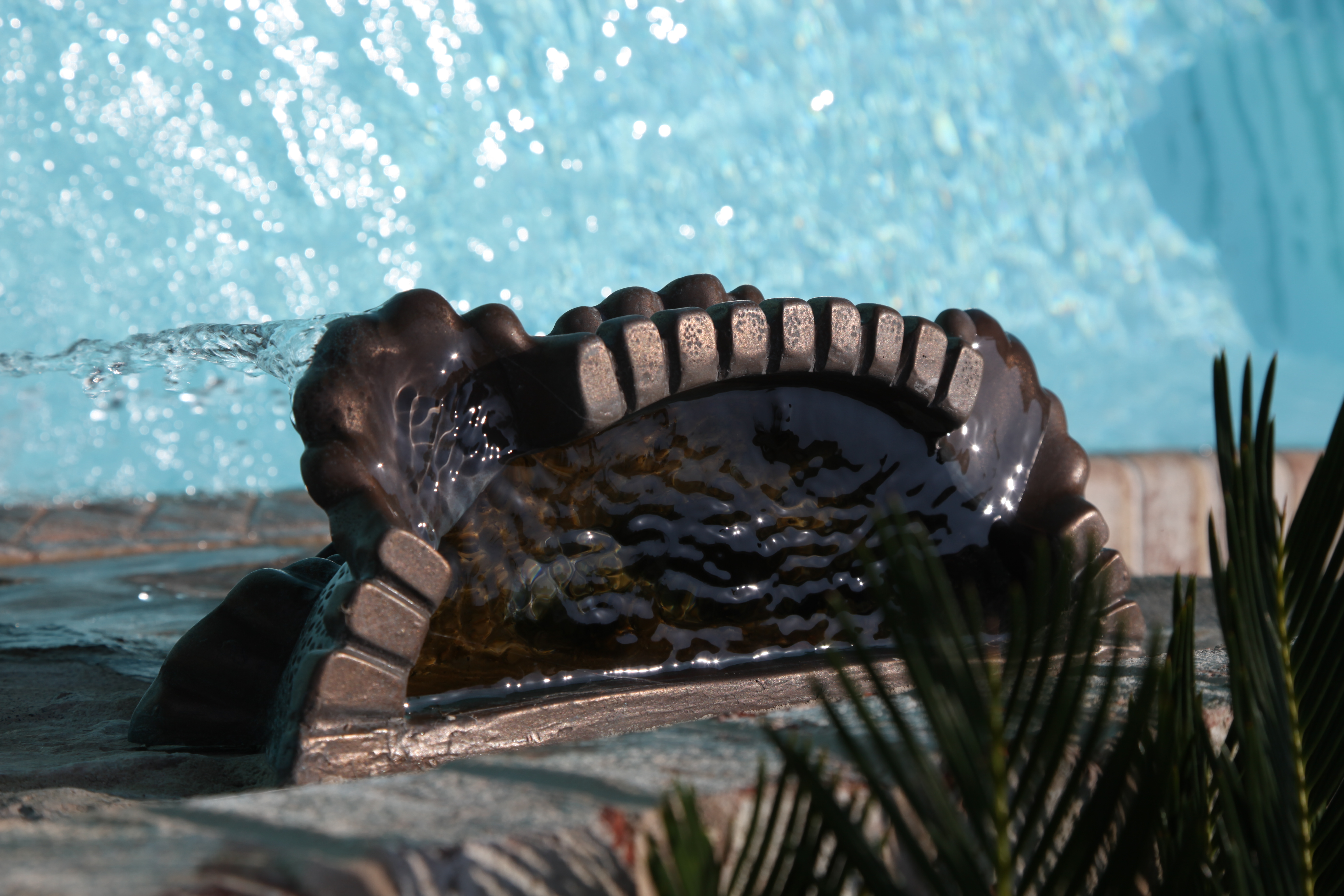 This exquisite stone seashell fountain, with its gentle water flow and lush greenery, brings a serene, natural ambiance to any outdoor setting.