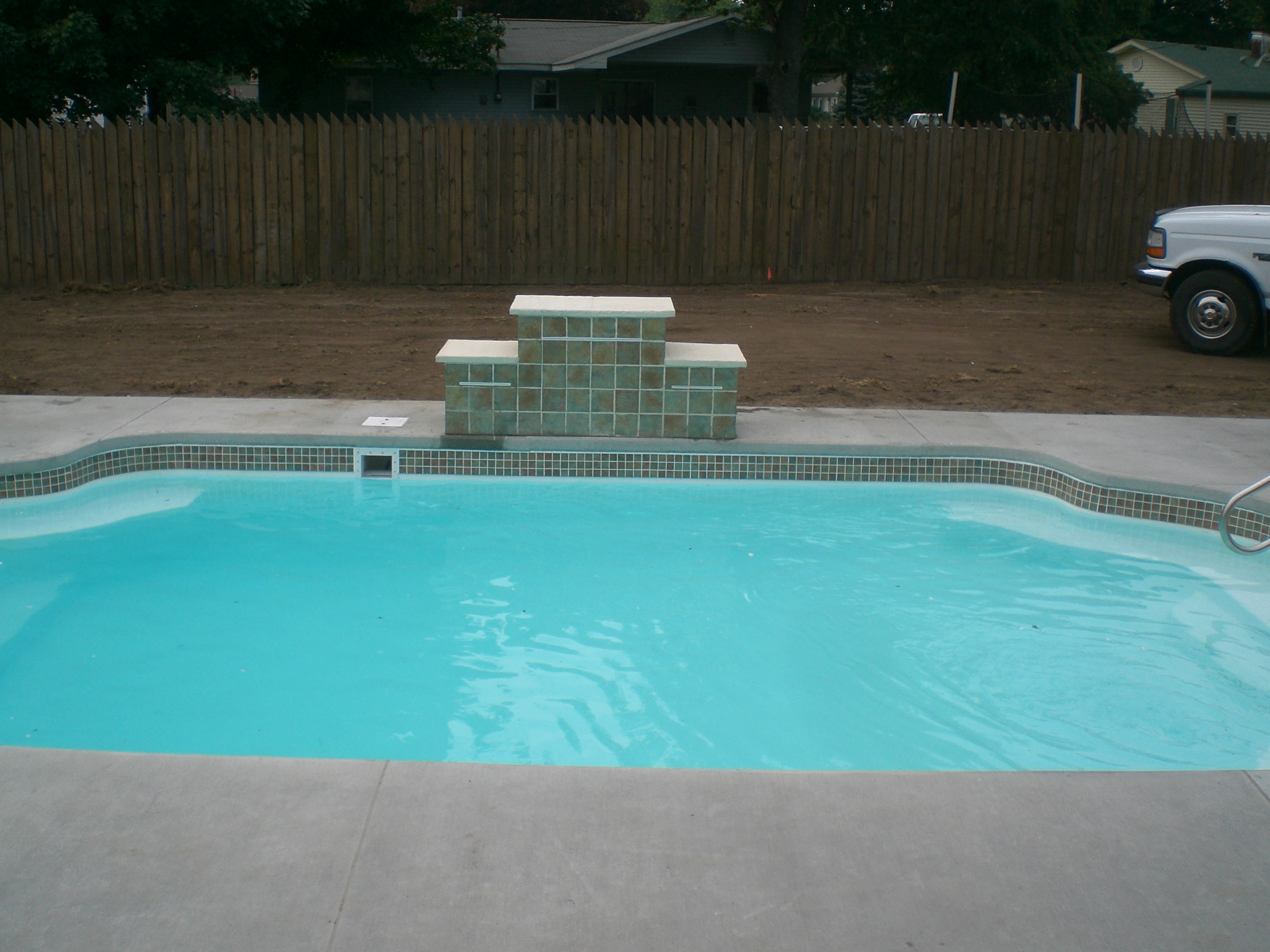 Discover the serenity of a pristine, in-ground fiberglass pool in your own backyard—ready to splash into summer relaxation.
