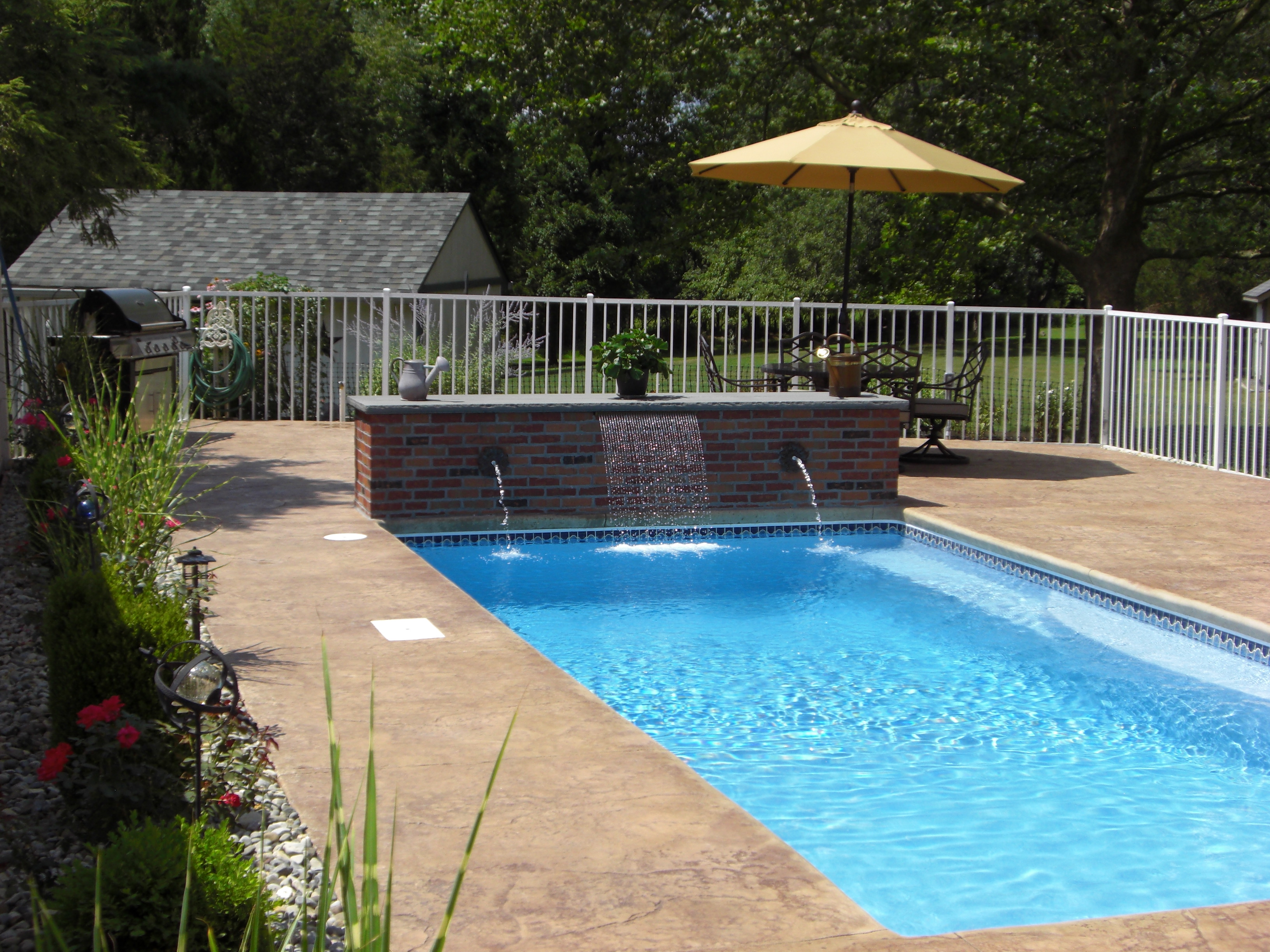 Enjoy the sunny comfort of a newly installed fiberglass in-ground pool, surrounded by a relaxing deck and patio perfect for outdoor dining.