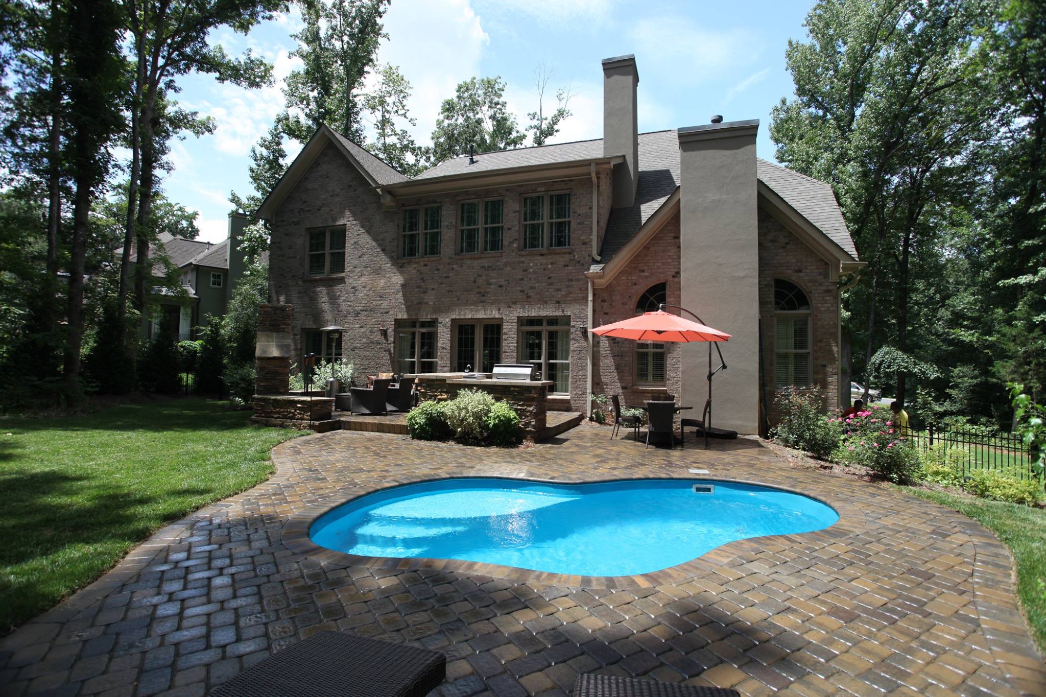 Enjoy a serene retreat with our fiberglass in-ground pool set in a beautifully landscaped backyard.