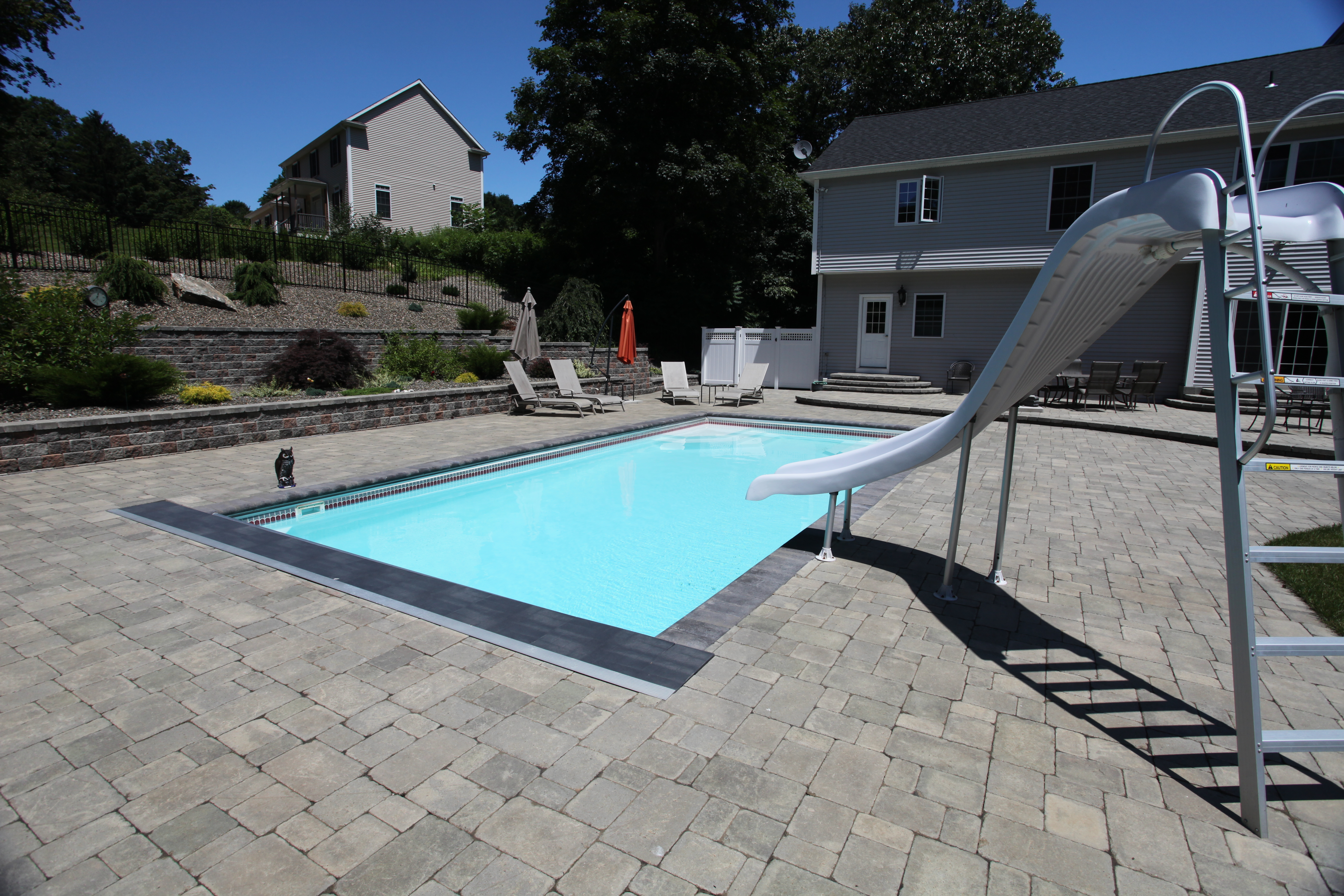 Discover relaxation with our sleek, durable fiberglass inground pool, surrounded by a beautiful backyard oasis.