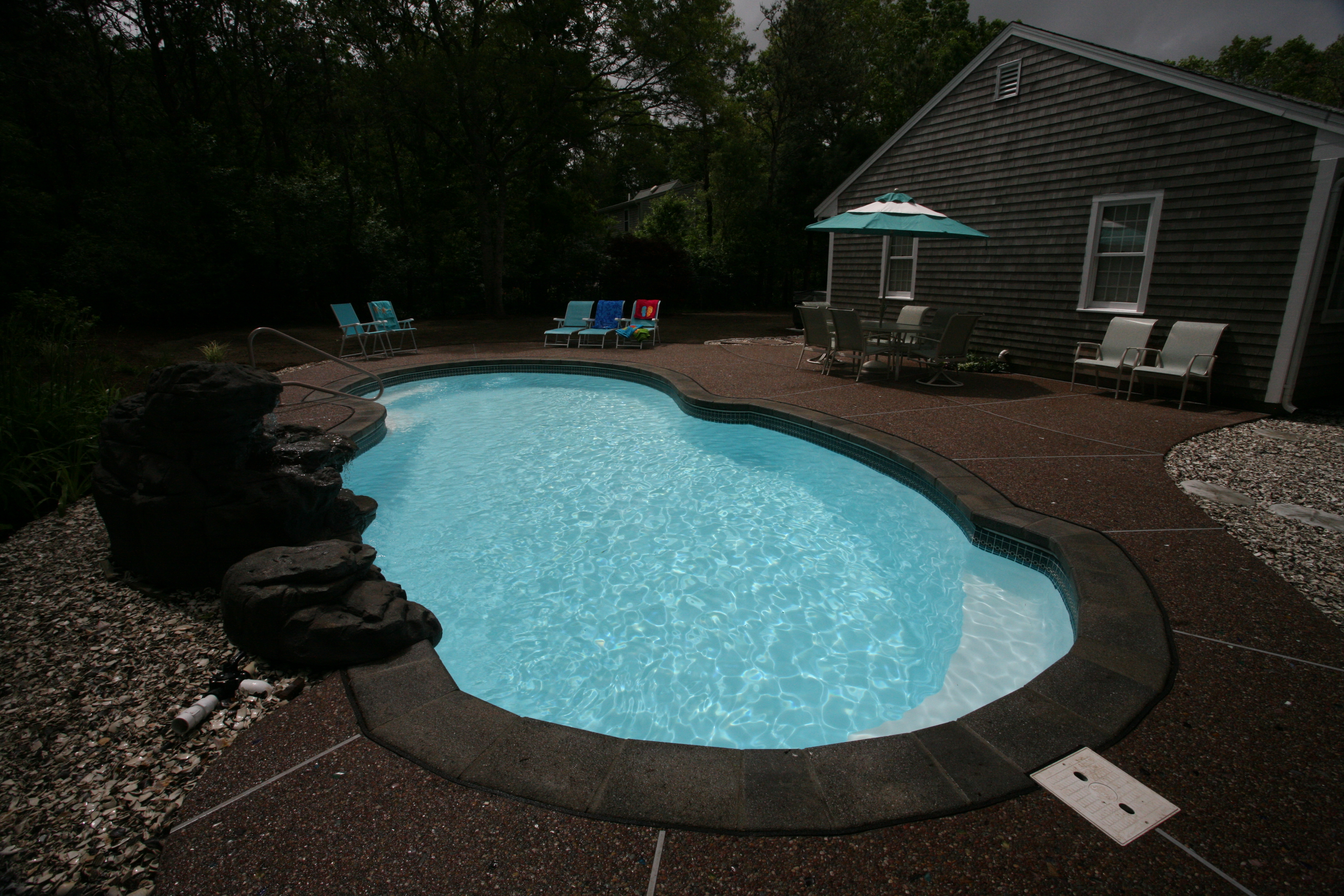 Experience the tranquility of a San Juan Fiberglass Pool, an expertly crafted in-ground pool with a luxurious hot tub—perfect for serene backyard relaxation.