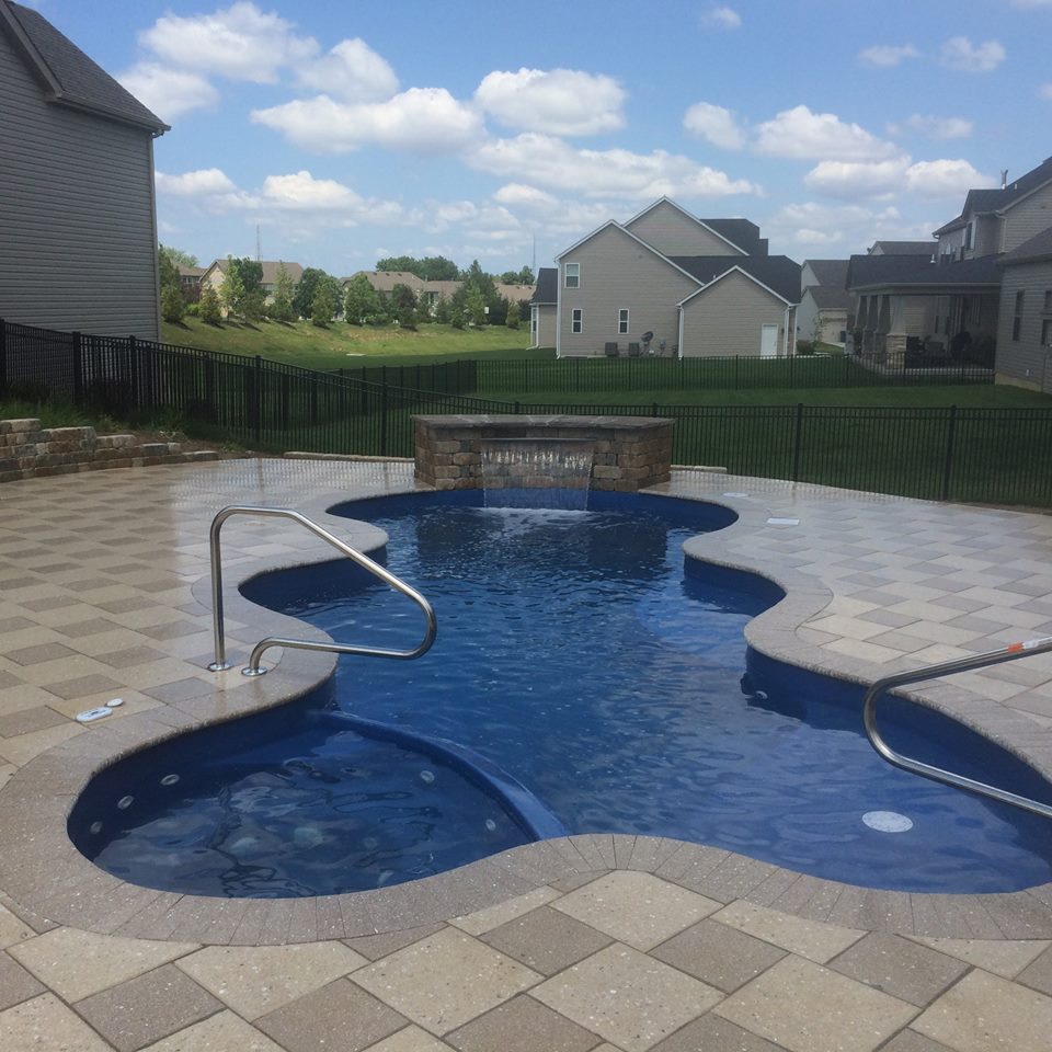 Experience the pristine clarity of our fiberglass inground pool, nestled in a lush backyard oasis that invites you to unwind under the sun.
