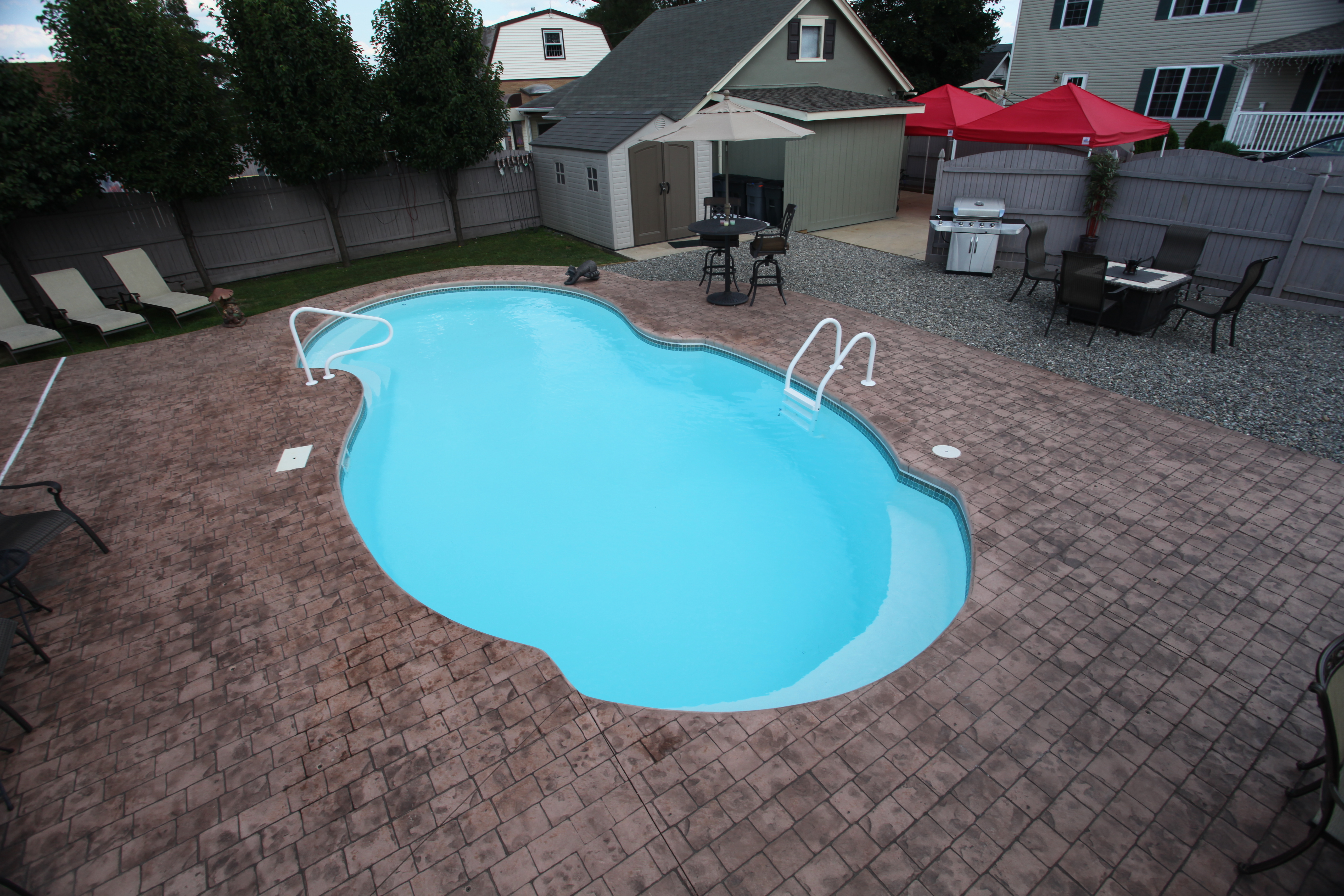 Enjoy serene, low-maintenance luxury in your backyard with our high-performance fiberglass pool, featuring a sleek kidney shape and elegant stone decking.