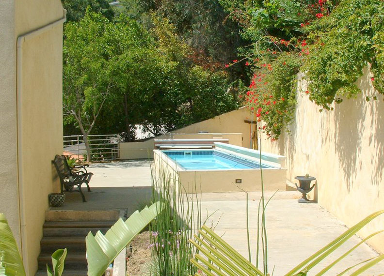 Experience the serenity of a pristine fiberglass pool in your own backyard—perfect for relaxed summer days.