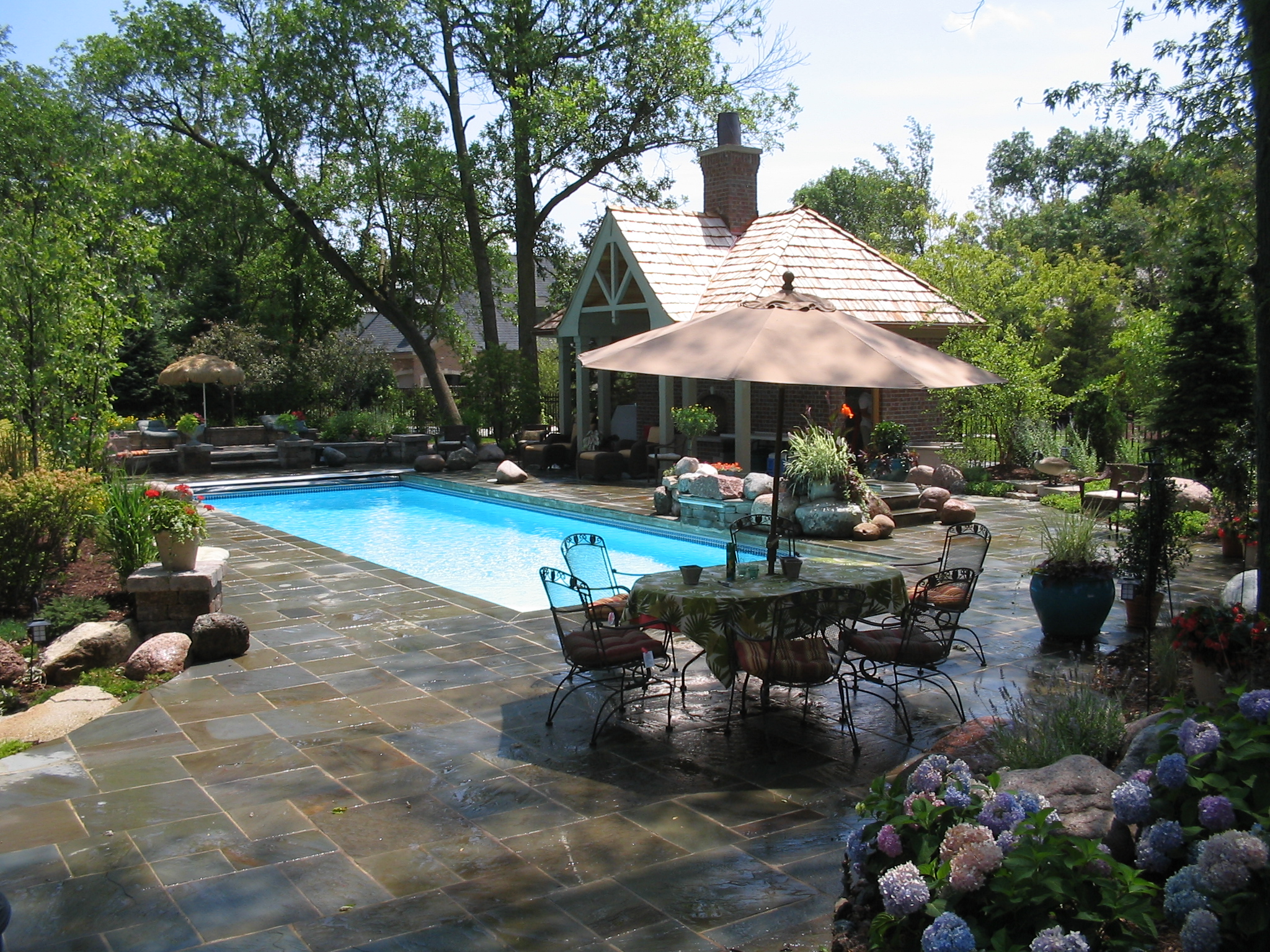 Experience the serene luxury of a San Juan fiberglass pool, the centerpiece of a sun-kissed backyard oasis perfect for relaxation.