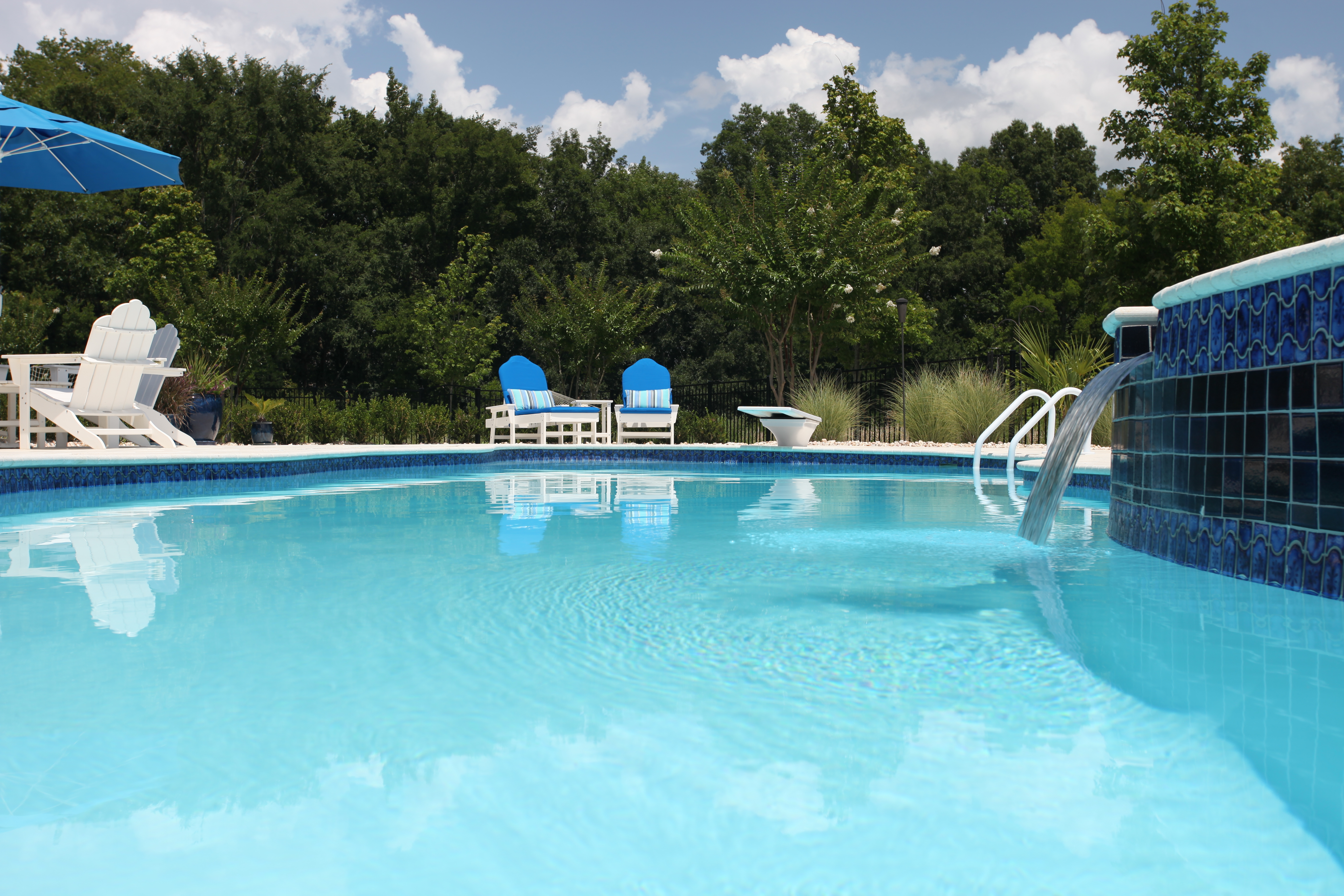 Experience pure relaxation with this pristine San Juan fiberglass pool, set in a sun-kissed backyard oasis.