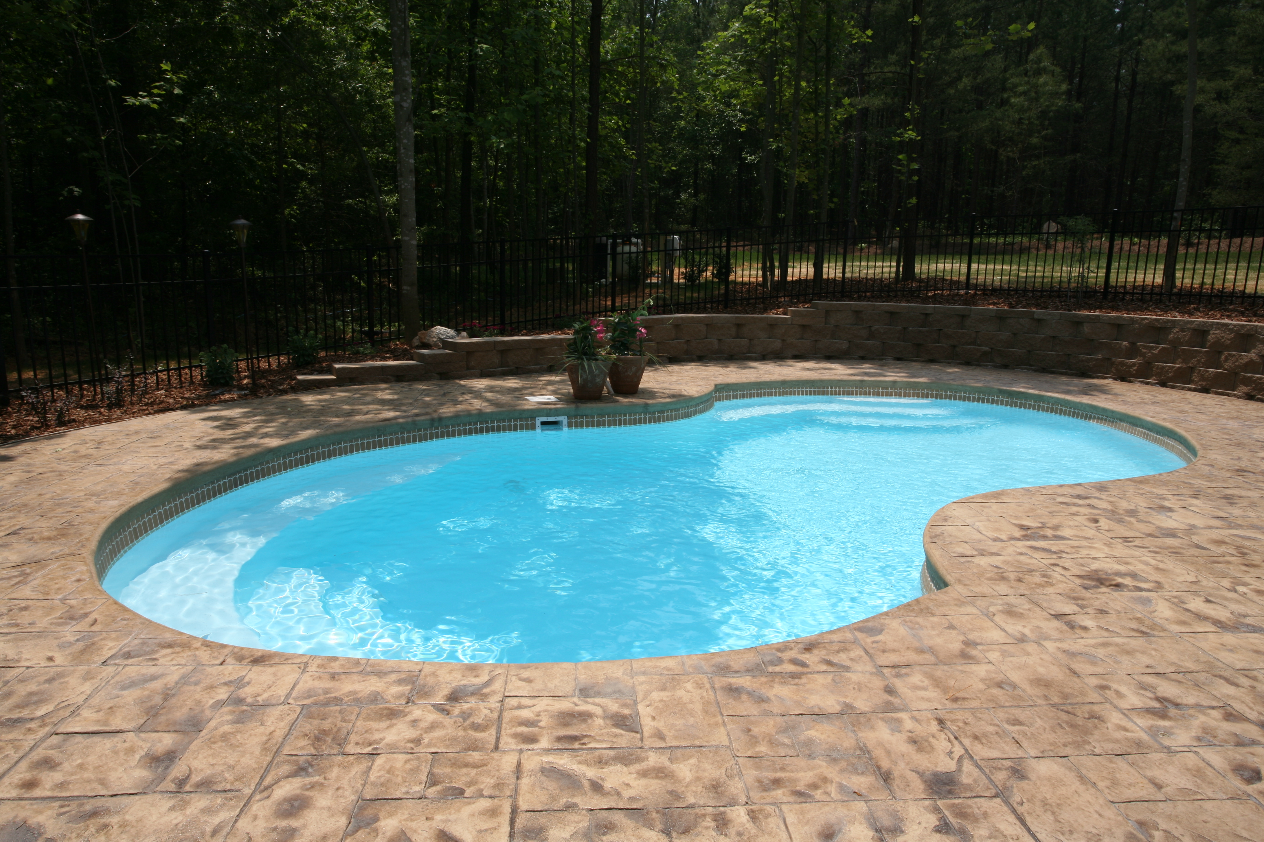 Enjoy the serenity of this beautifully maintained fiberglass pool, perfect for tranquil backyard retreats.