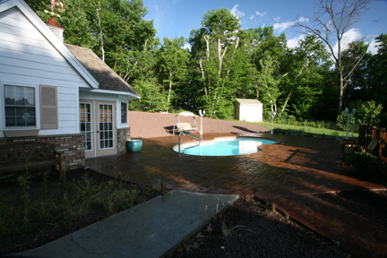 Enjoy sun-kissed relaxation in this pristine fiberglass kidney-shaped pool, set in a serene suburban backyard.