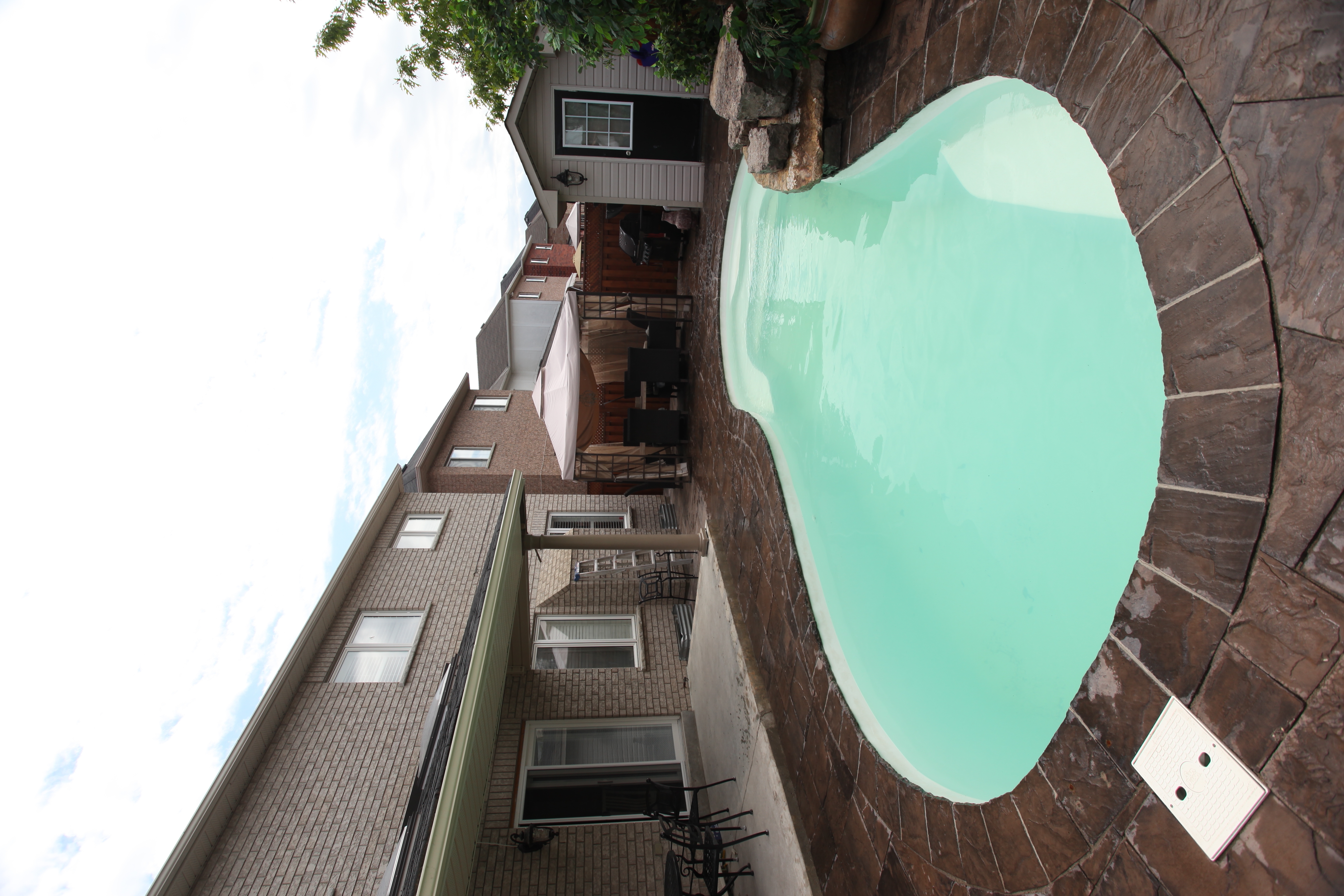 Experience the tranquil, fiberglass San Juan pool, set in a sun-kissed backyard oasis with sleek stone patio and vibrant turquoise water.
