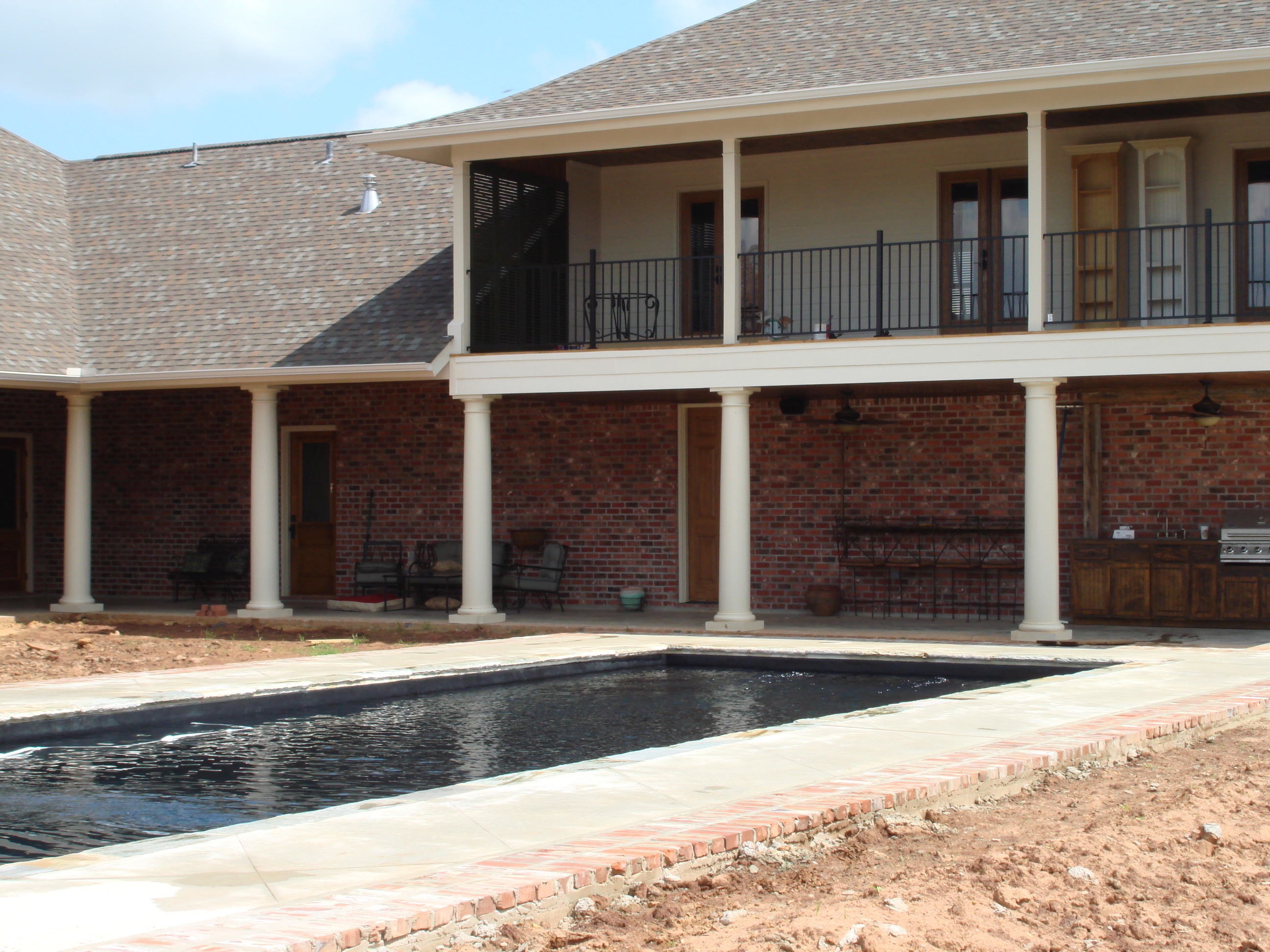 Enjoy crystal-clear, sun-kissed swims in this brand-new fiberglass pool, perfectly set against a modern brick-home backyard.