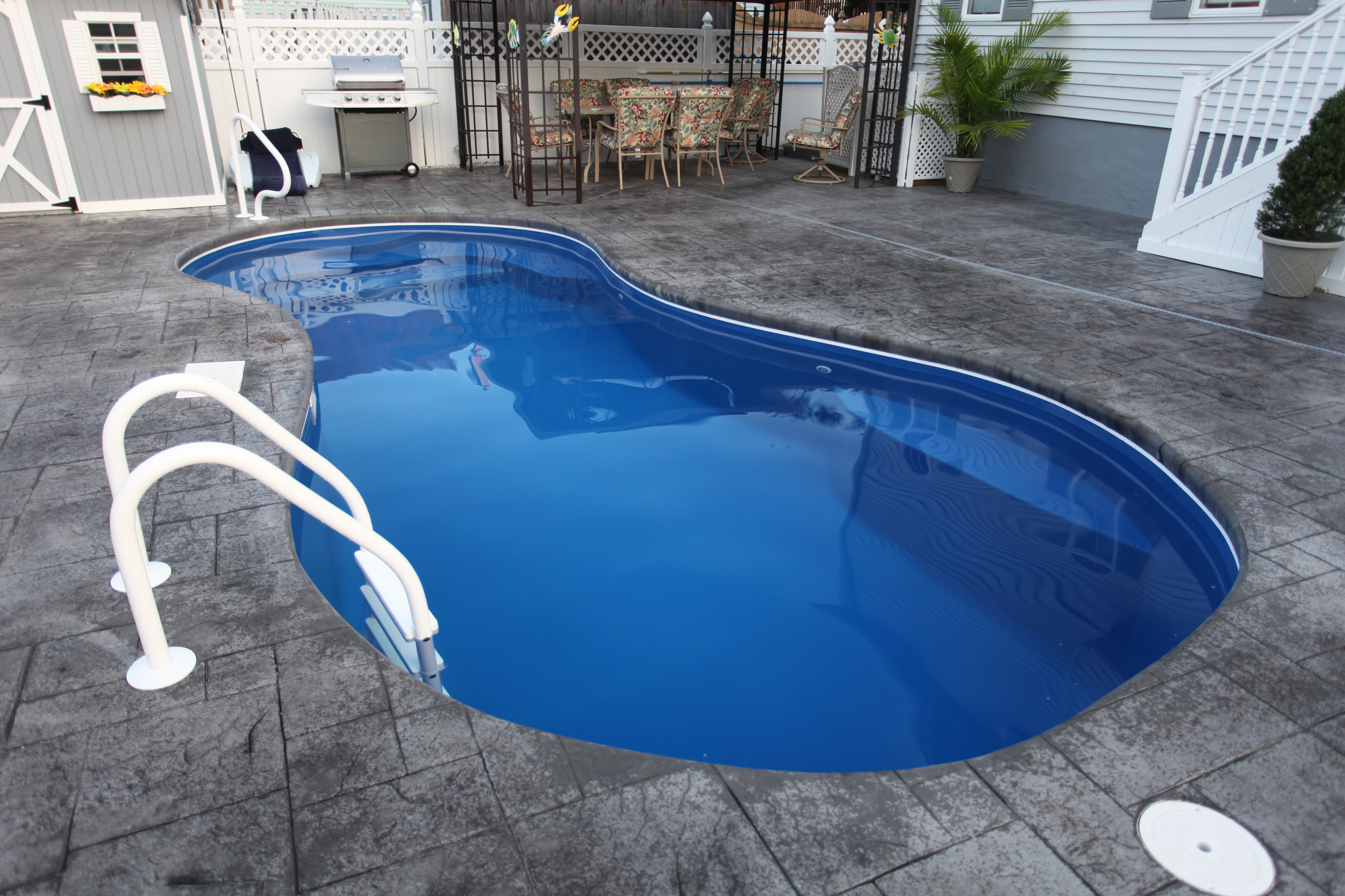 Experience serene backyard luxury with San Juan’s fiberglass kidney-shaped pool, featuring crystal-clear blue water and a sleek, low-maintenance design.