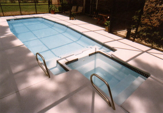 Experience the serene elegance of a freshly installed fiberglass pool, bathed in warm midday light and framed by a tranquil backyard oasis.