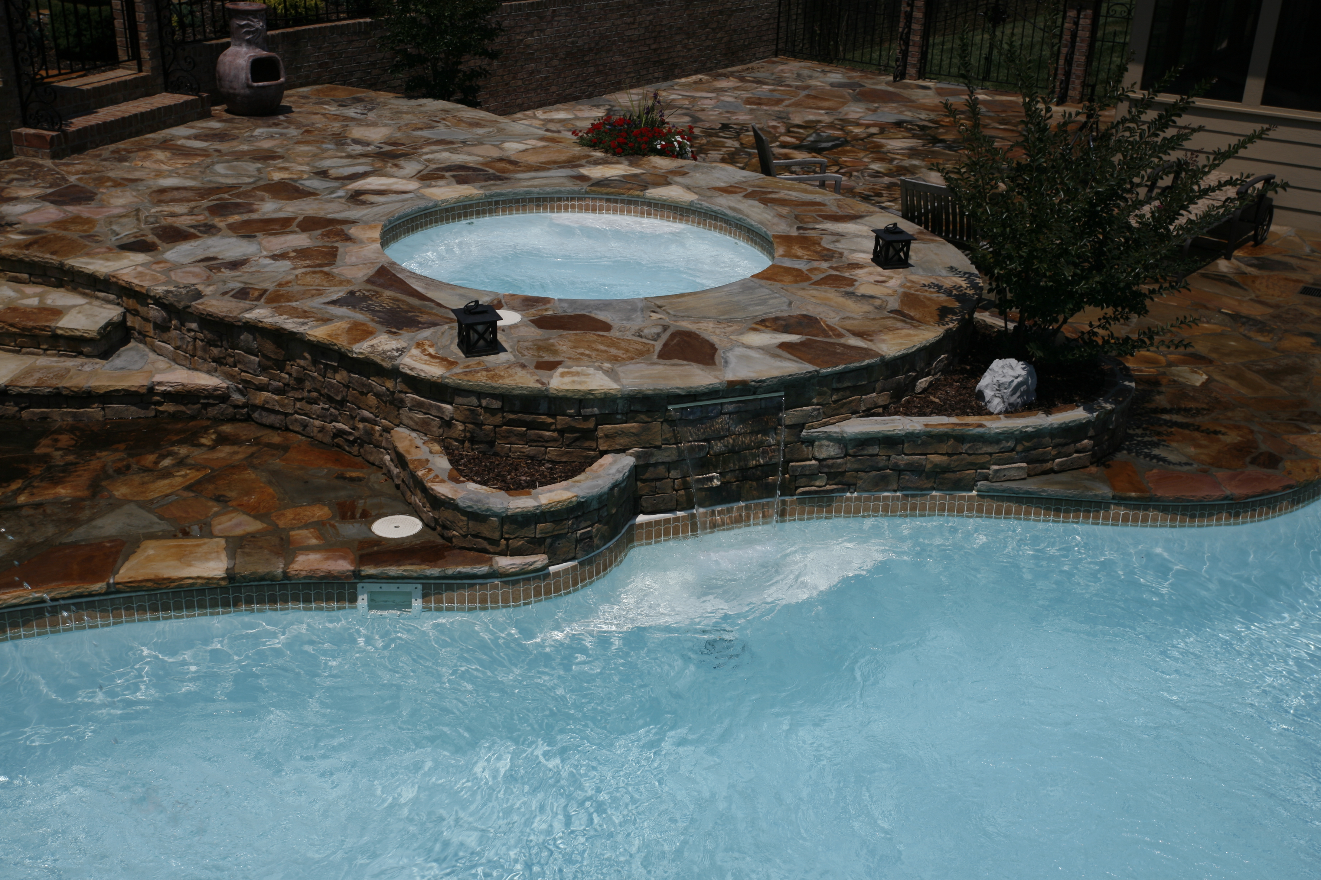 A serene backyard oasis featuring a stunning inground pool, perfect for relaxation and entertainment. The modern design and warm lighting create an inviting atmosphere, ideal for spending time with family and friends.