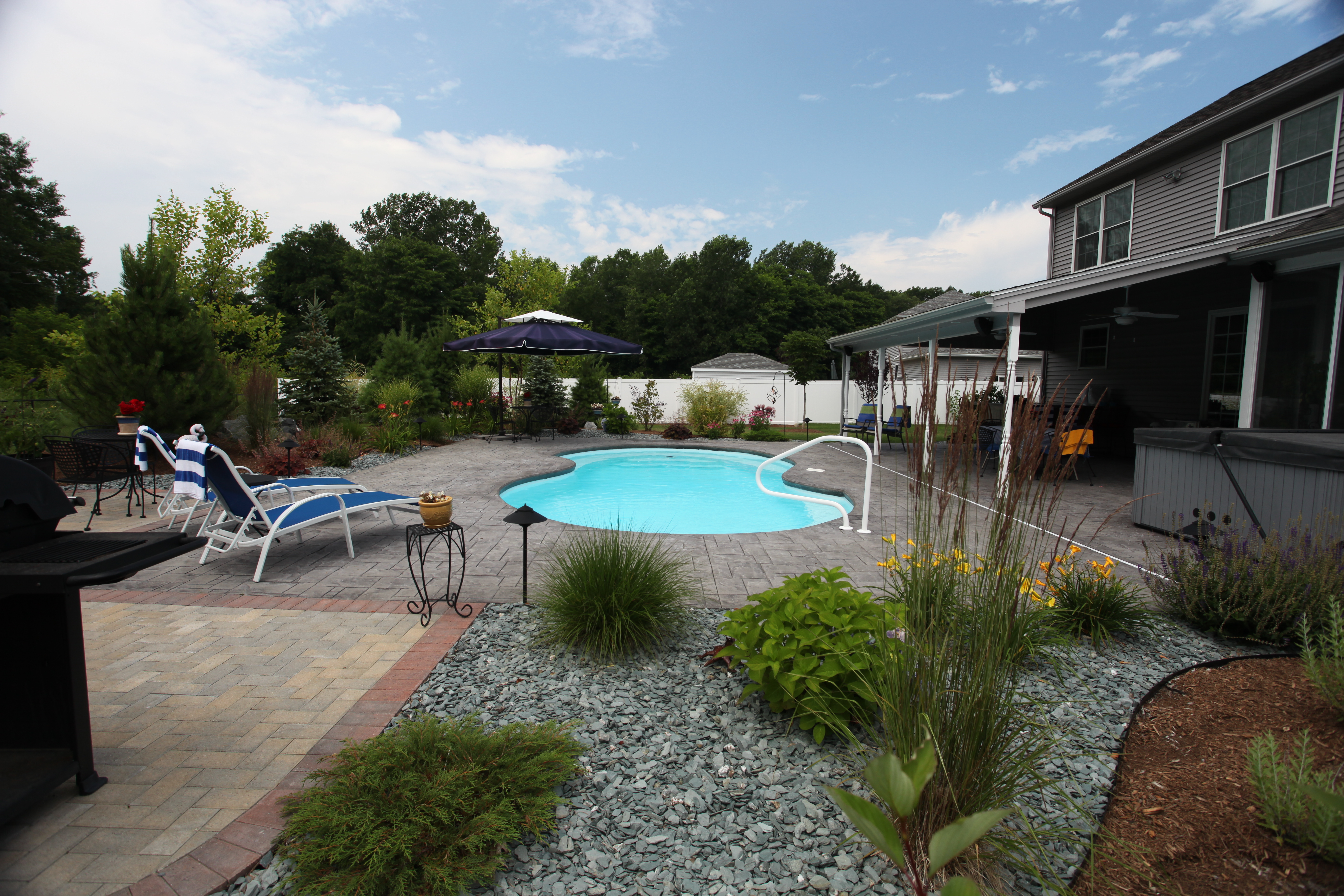 Escape to this serene backyard oasis featuring a stunning fiberglass kidney-shaped pool, perfect for relaxation and recreation.