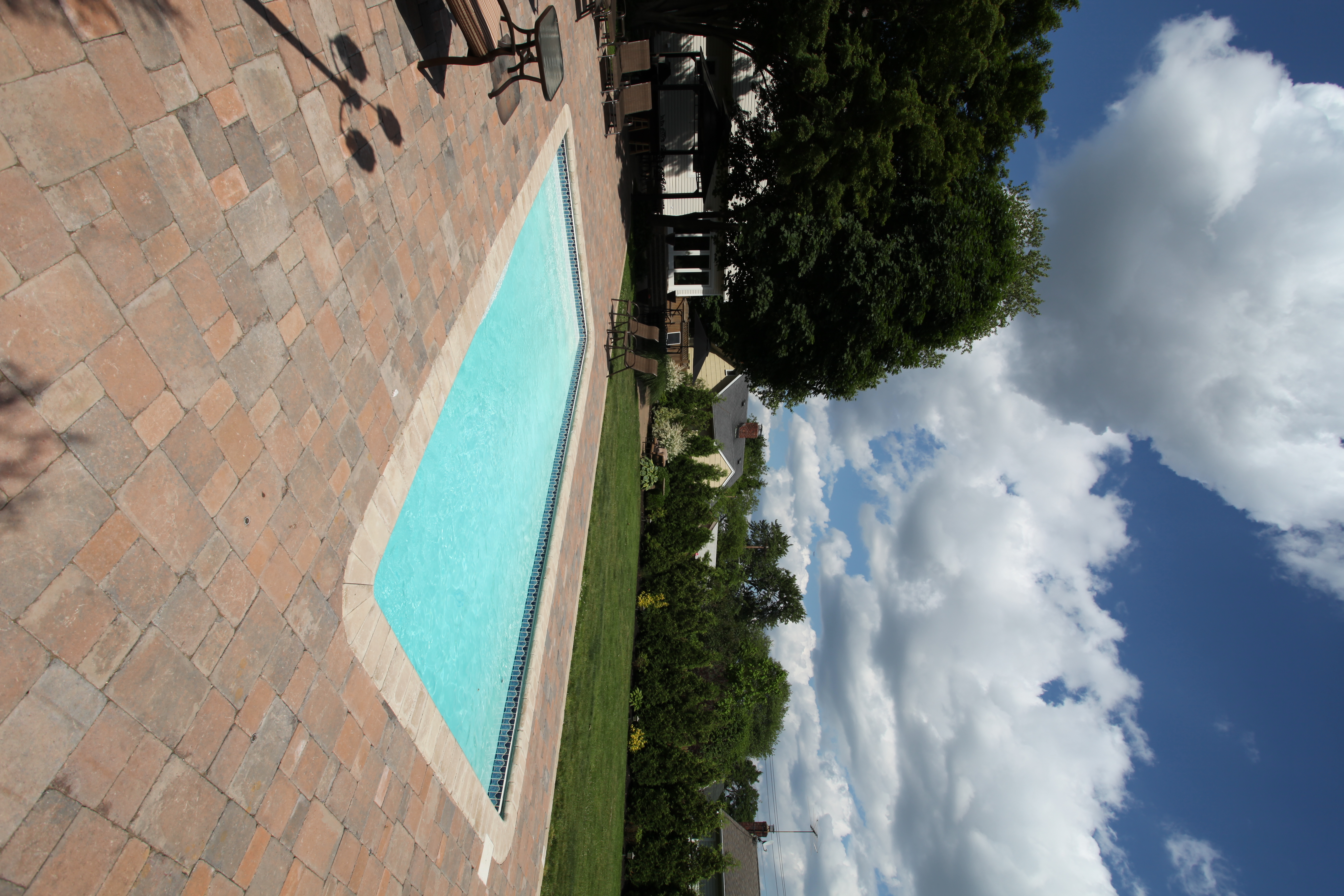 Enjoy a serene backyard oasis with San Juan’s brilliant blue fiberglass pool, perfect for sunny summer relaxation.