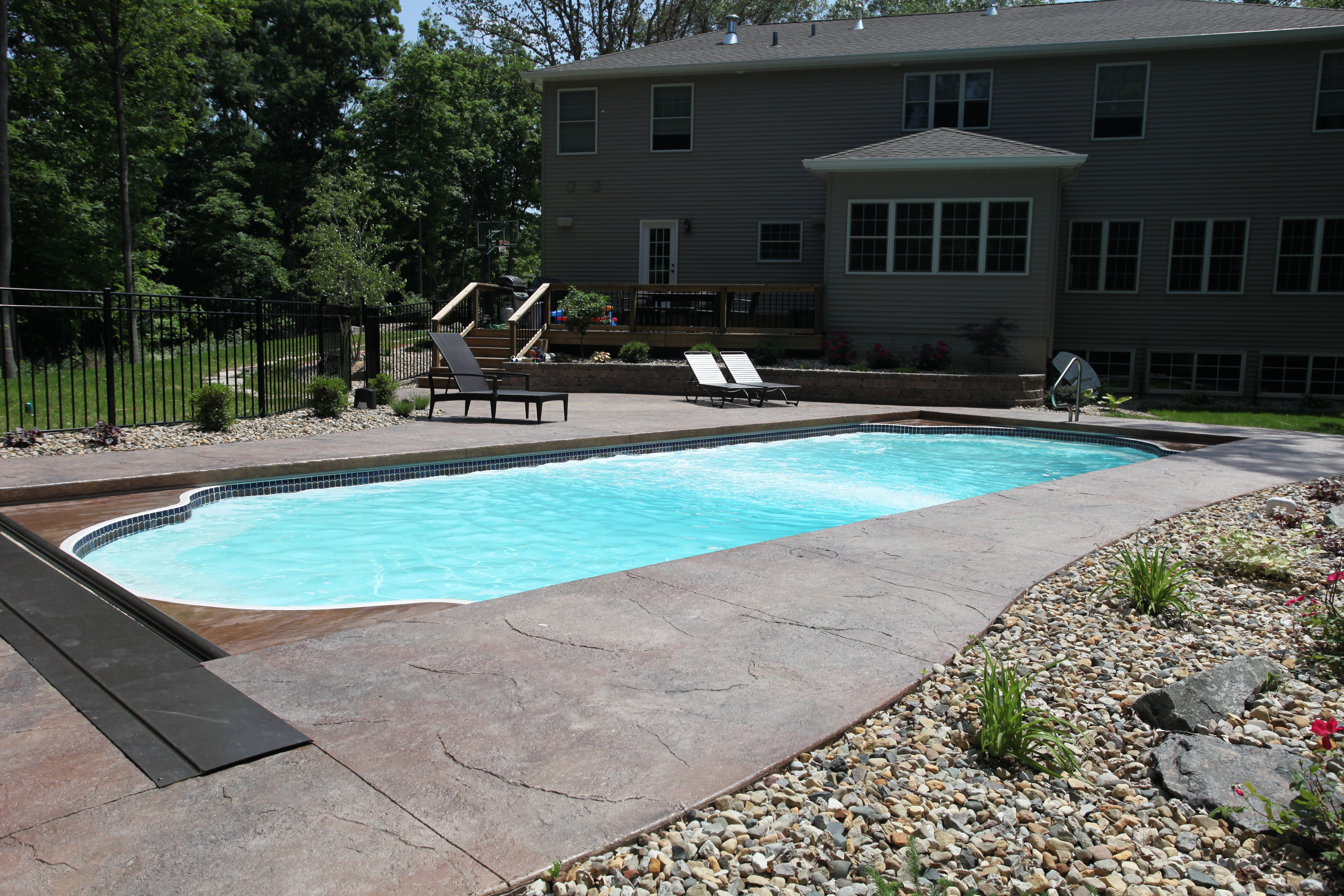 A serene inground pool in a Southwest desert backyard, perfect for warm summer days. The classic design and natural surroundings create a relaxing atmosphere.