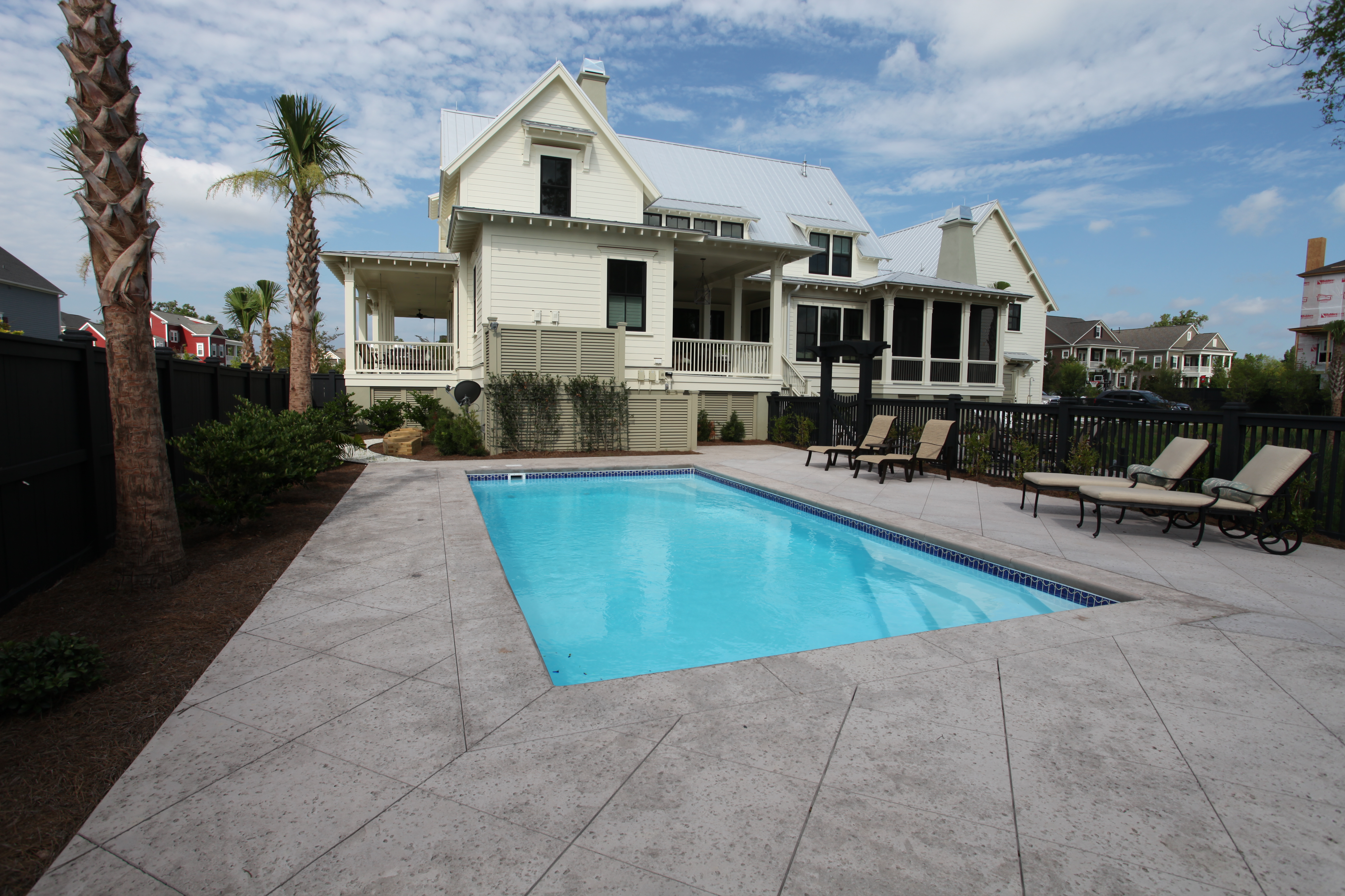 A serene backyard oasis featuring a modern inground pool, perfect for relaxation and leisure. The warm and natural ambiance invites you to unwind in style.