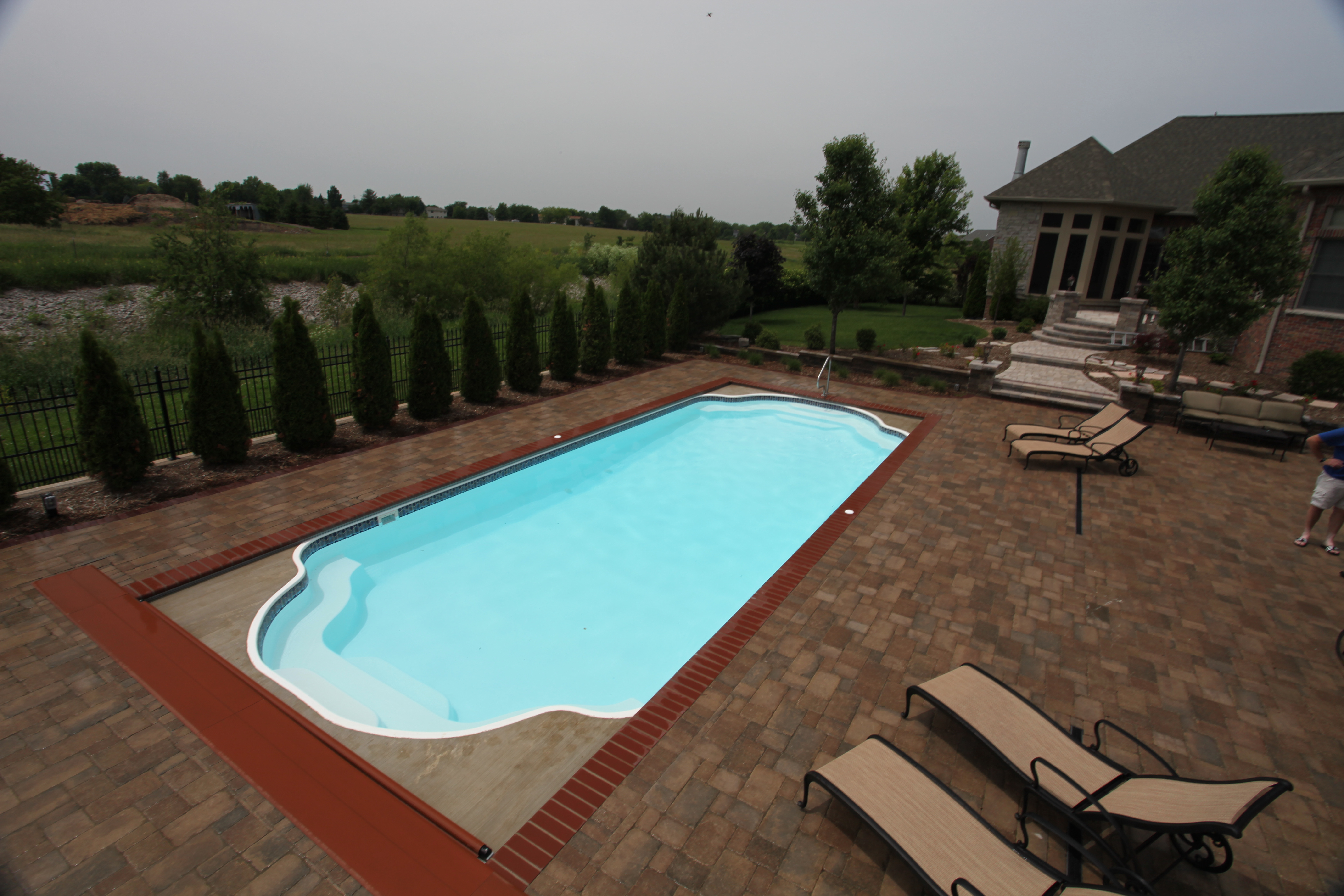 Escape to this serene fiberglass pool oasis, perfectly blending with its coastal surroundings.