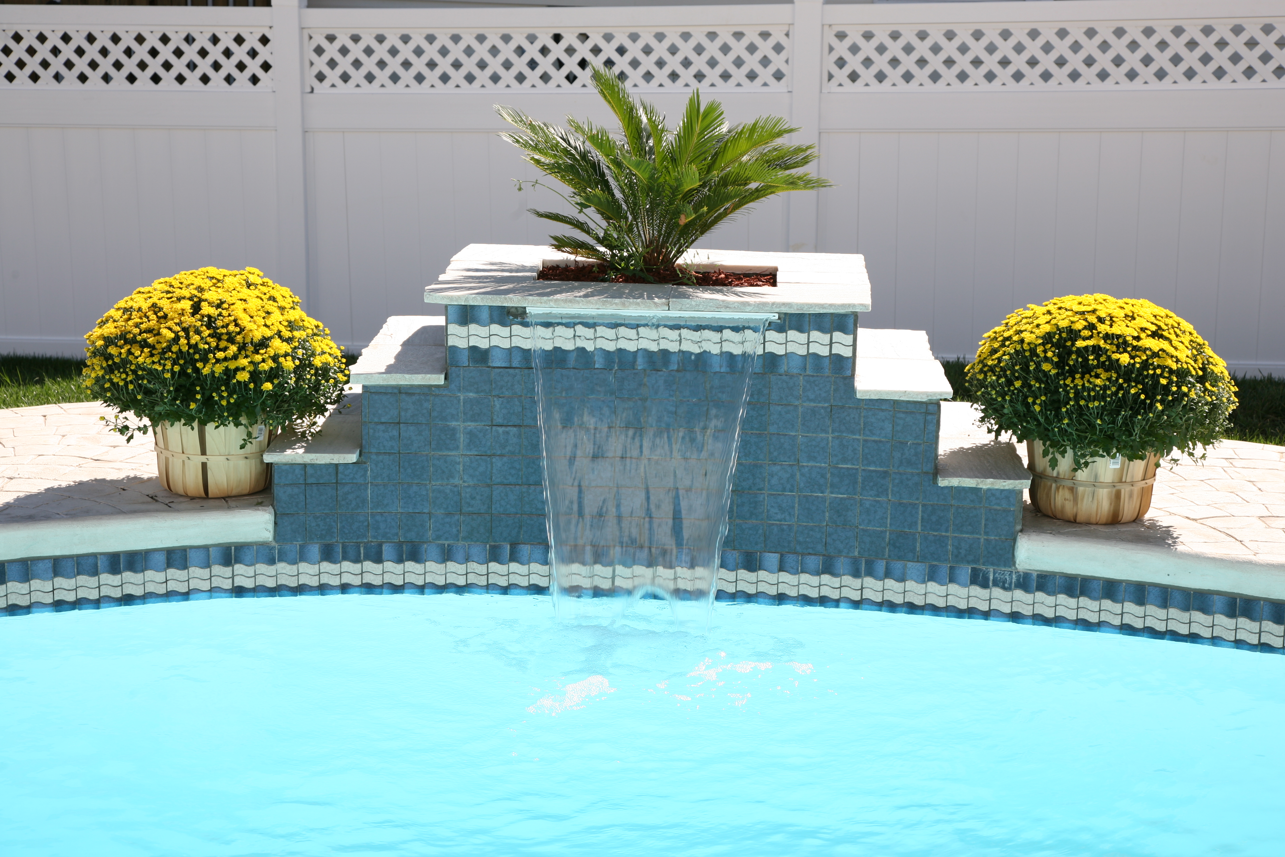 A serene backyard oasis featuring a modern inground pool, perfect for relaxation and resort-like ambiance. This warm and inviting setting is ideal for any season, offering a tranquil escape from the hustle and bustle of daily life.