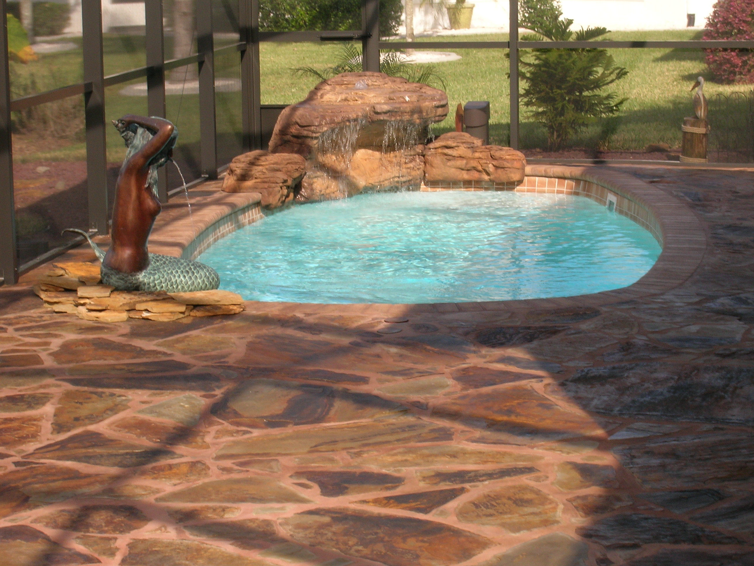 A serene backyard oasis in the desert southwest, complete with a beautiful inground pool and warm, sunny weather. Perfect for relaxation and summer fun.