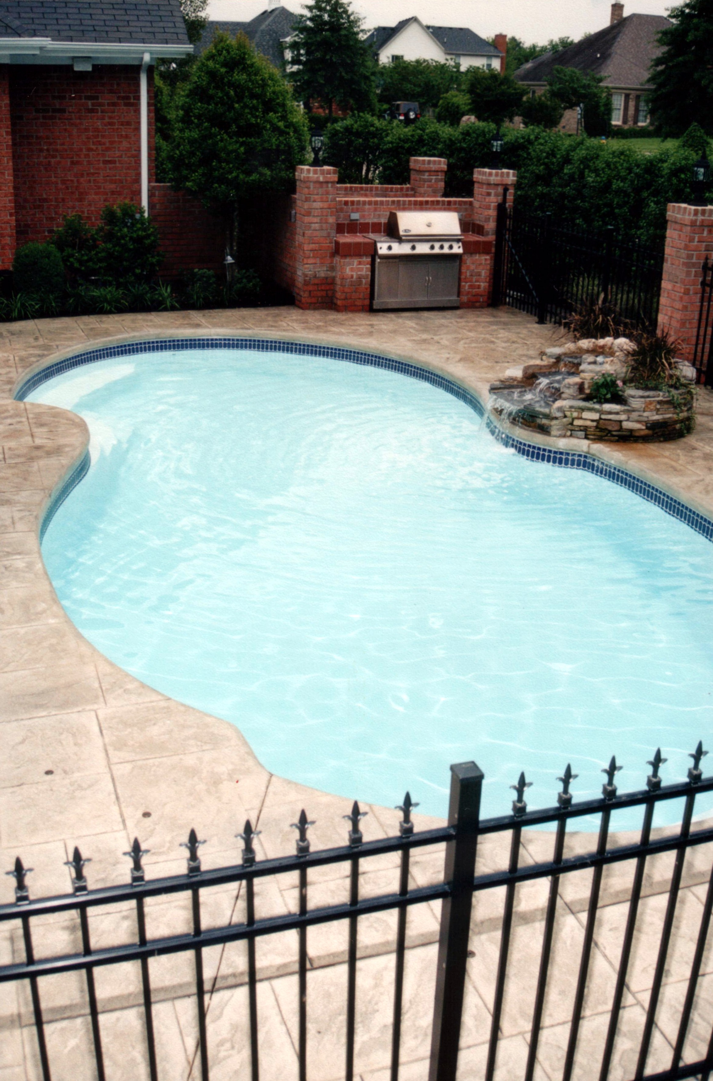 A serene backyard oasis featuring an inground pool, perfect for hot desert summers. The modern aesthetic and natural surroundings create a relaxing atmosphere ideal for family gatherings or quiet retreats.
