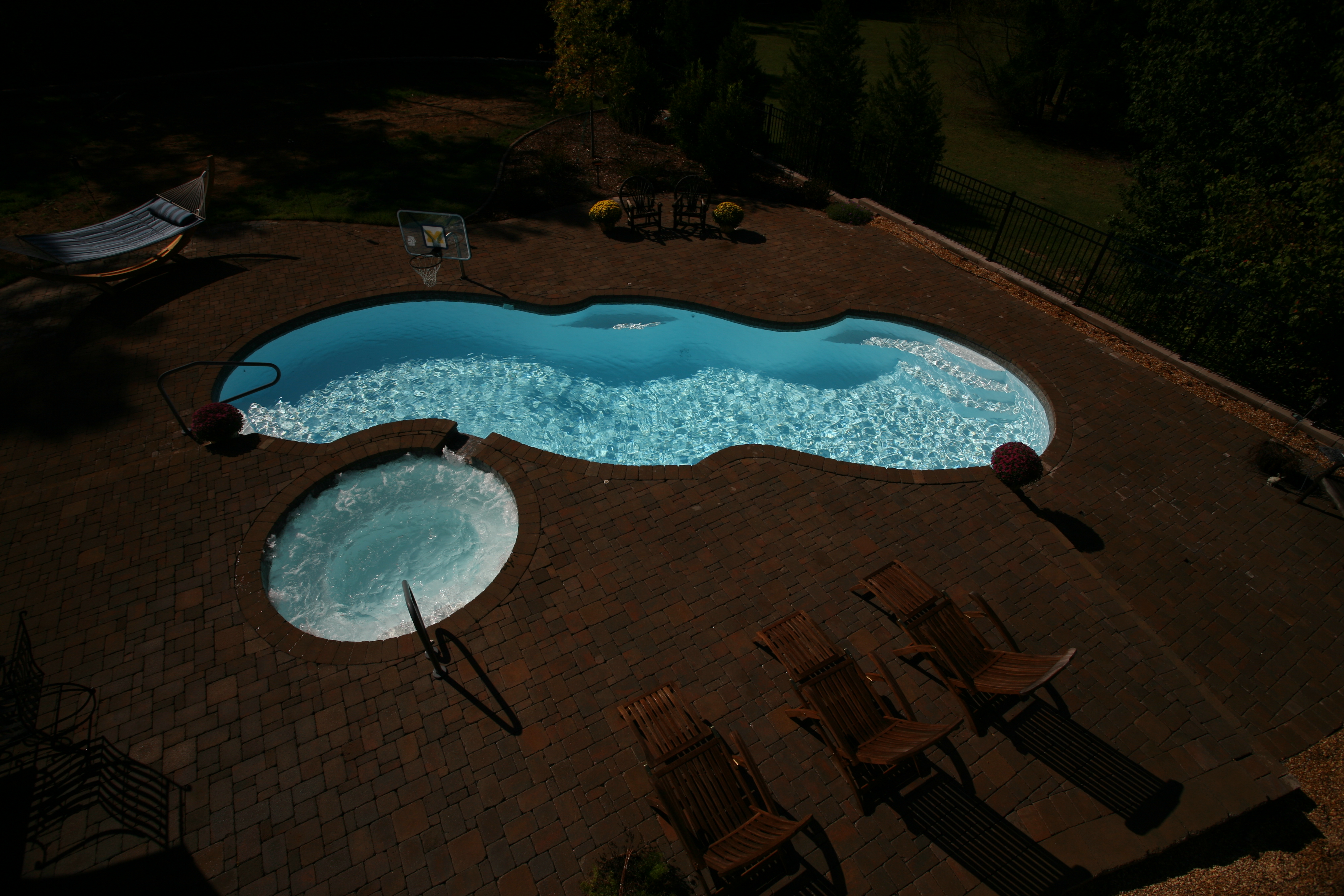 Immerse yourself in this serene fiberglass pool backyard oasis, perfect for relaxation and recreation.