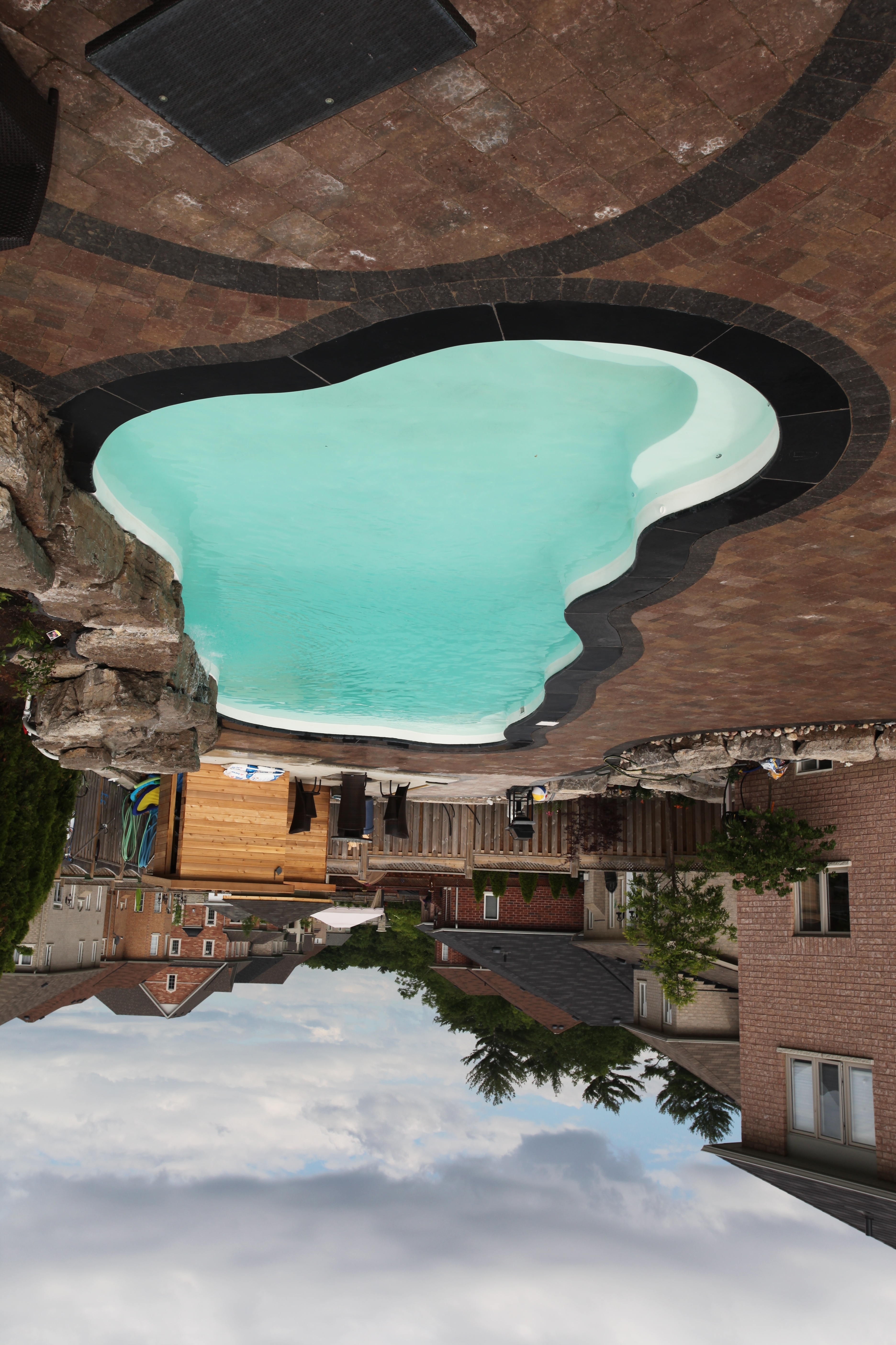 Experience relaxation with this unique, organic-shaped fiberglass pool nestled in a well-maintained backyard.
