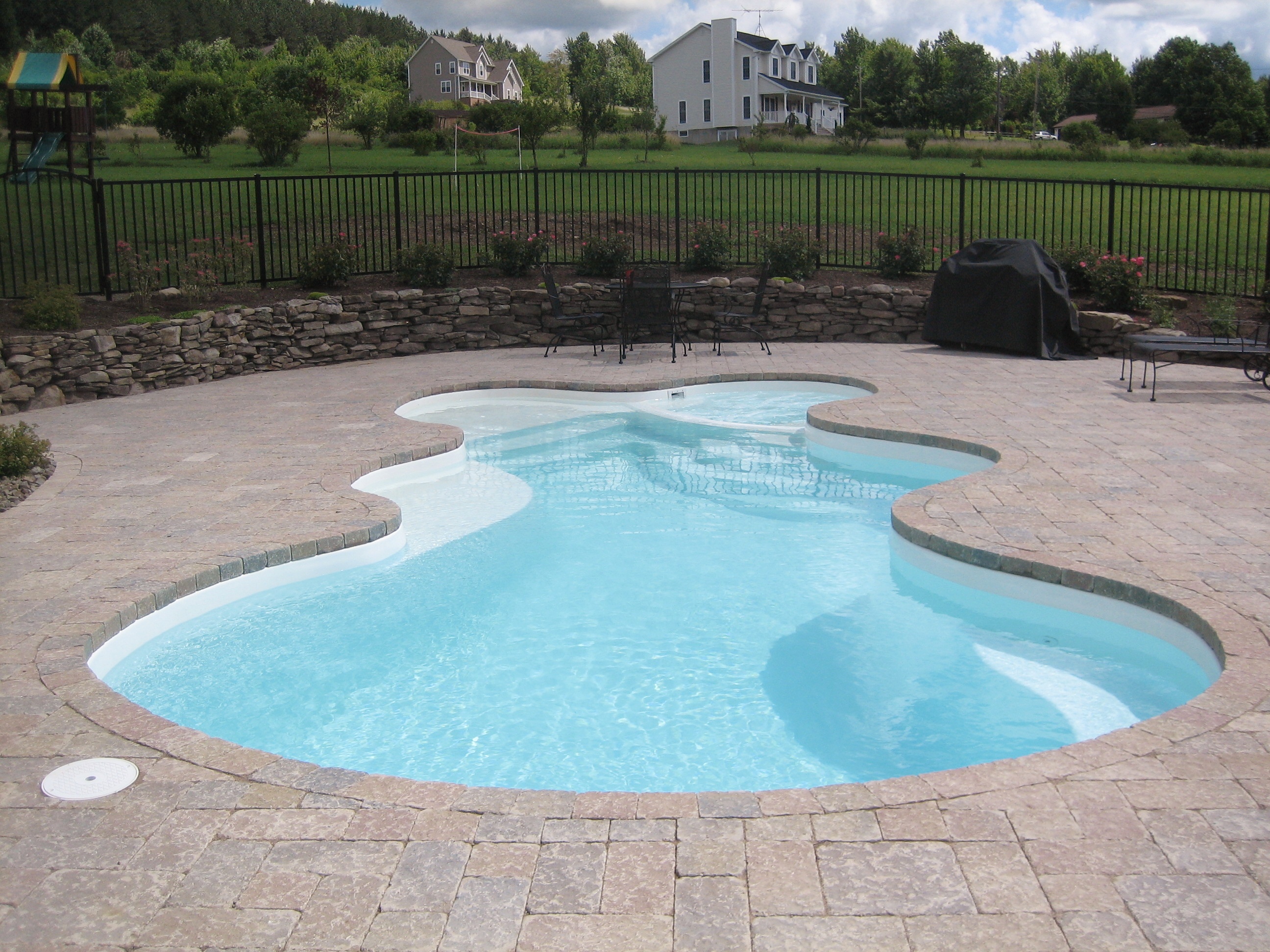 A serene backyard oasis in the desert southwest, featuring a modern inground pool perfect for summer relaxation. The warm, natural tones and vibrant colors create a welcoming atmosphere.
