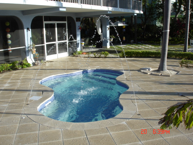 Enjoy a tranquil backyard oasis with San Juan’s vibrant blue fiberglass pool, perfectly suited for summer relaxation.